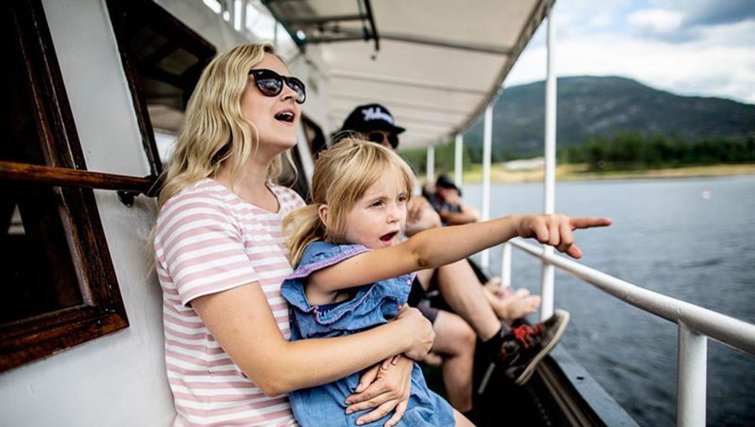 mother and daughter on deck of MS Fram and looking over goblins