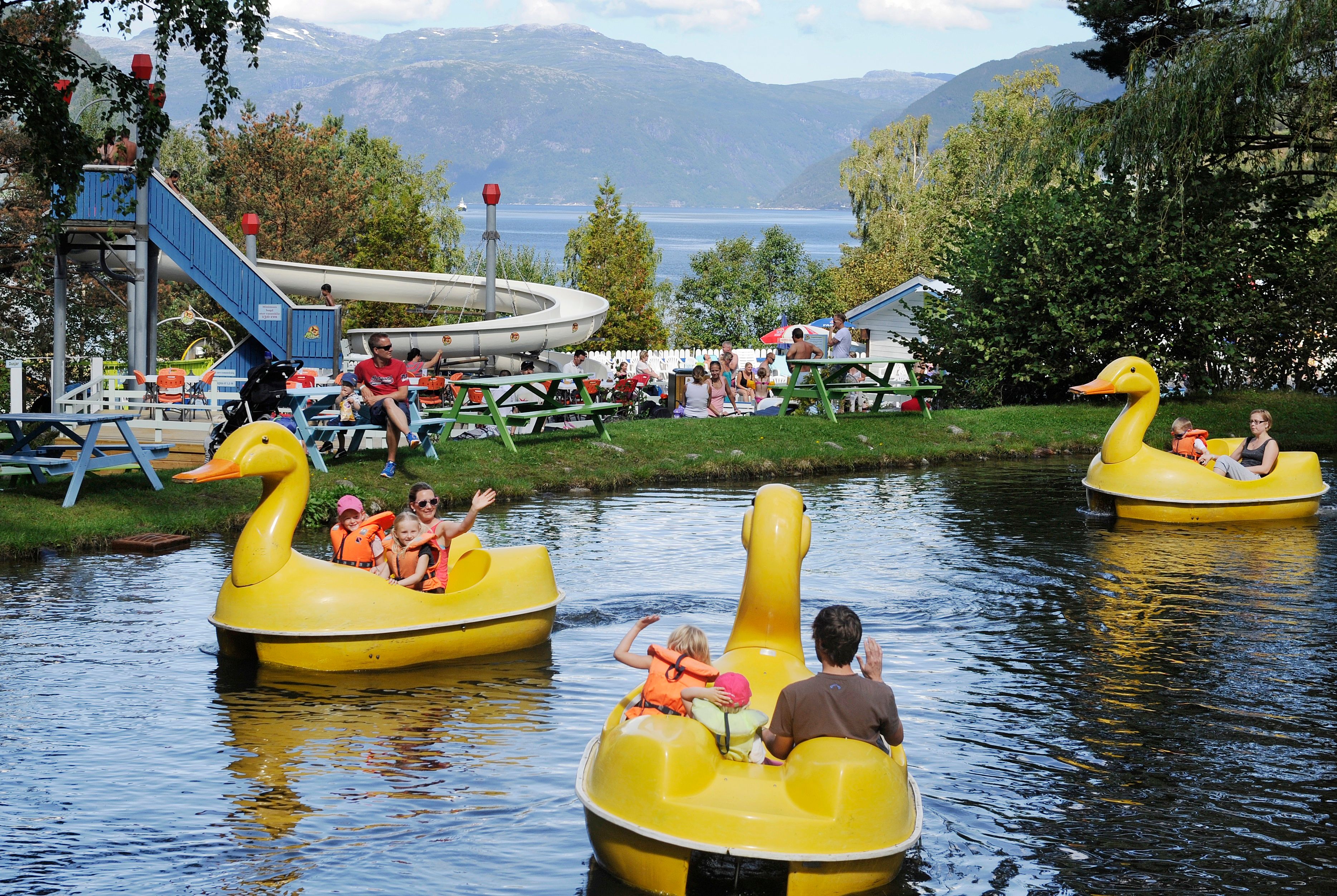 Family paddle boats shaped like ducks on the scenic duck pond at Mikkelparken