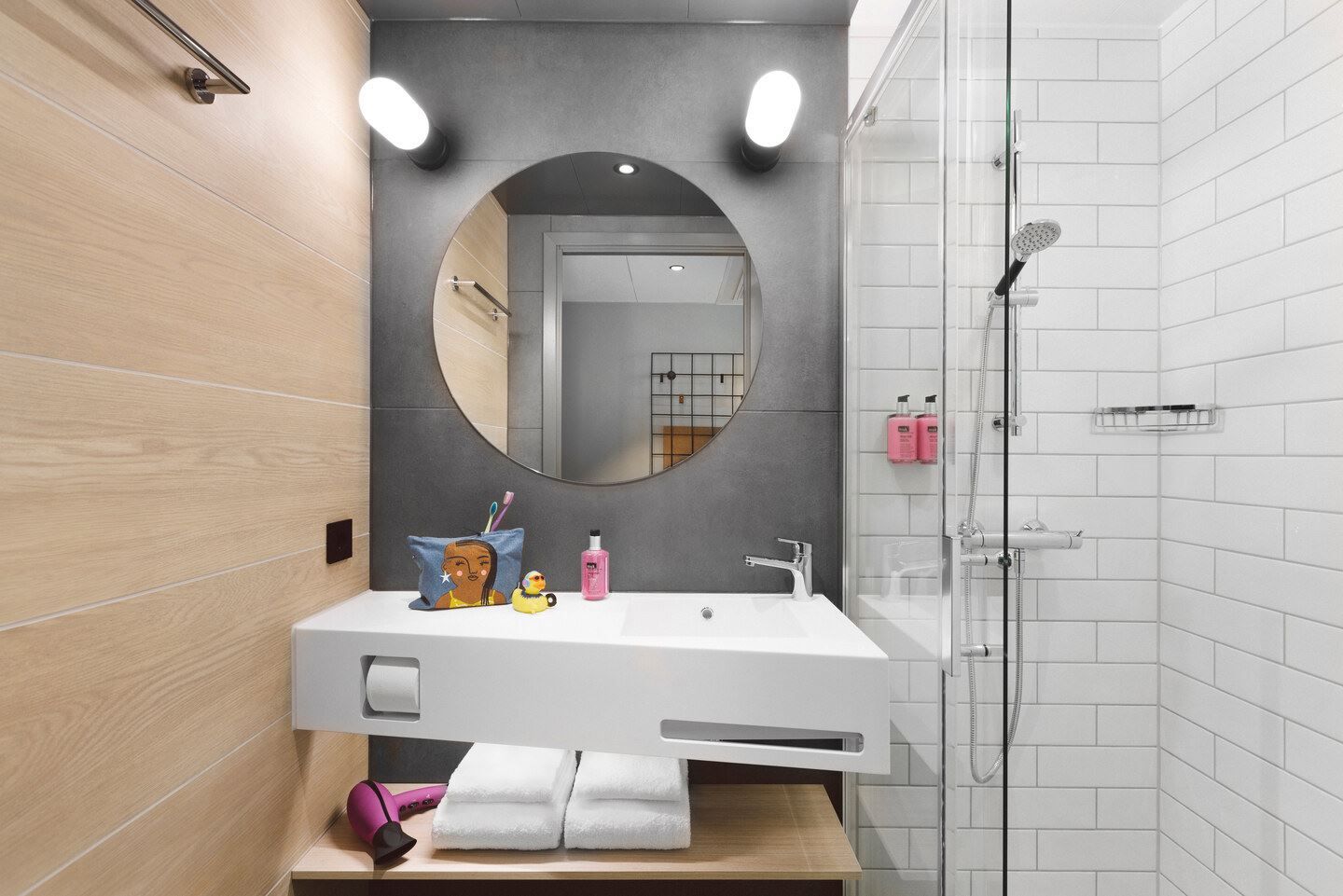 Bathroom in a standard room with a sink, shower and toilet.