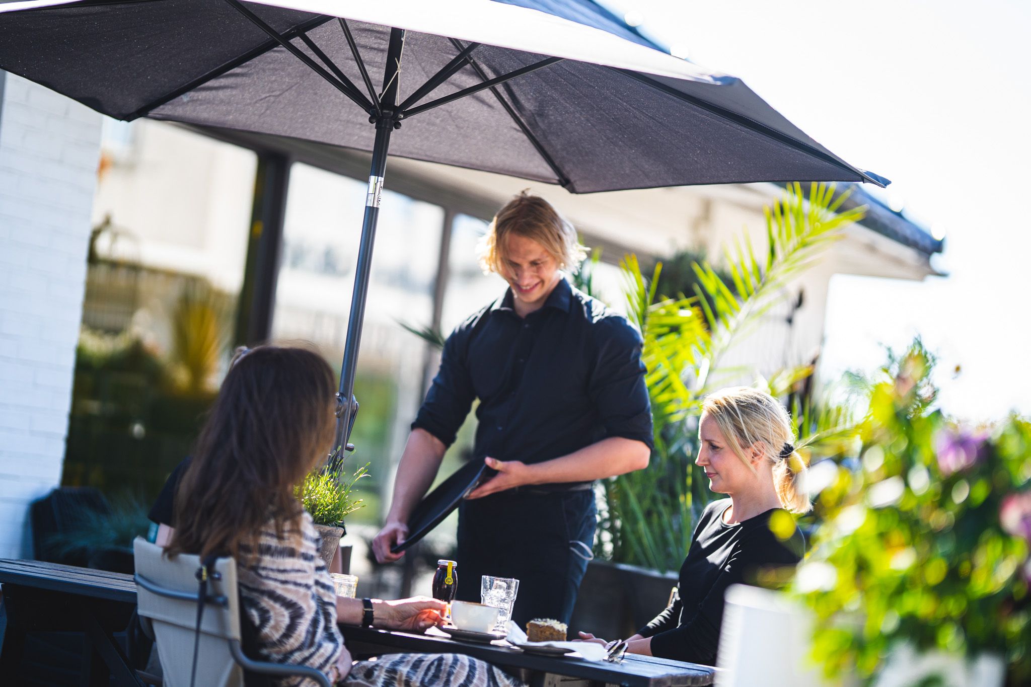 two woman having lunch and server taking order