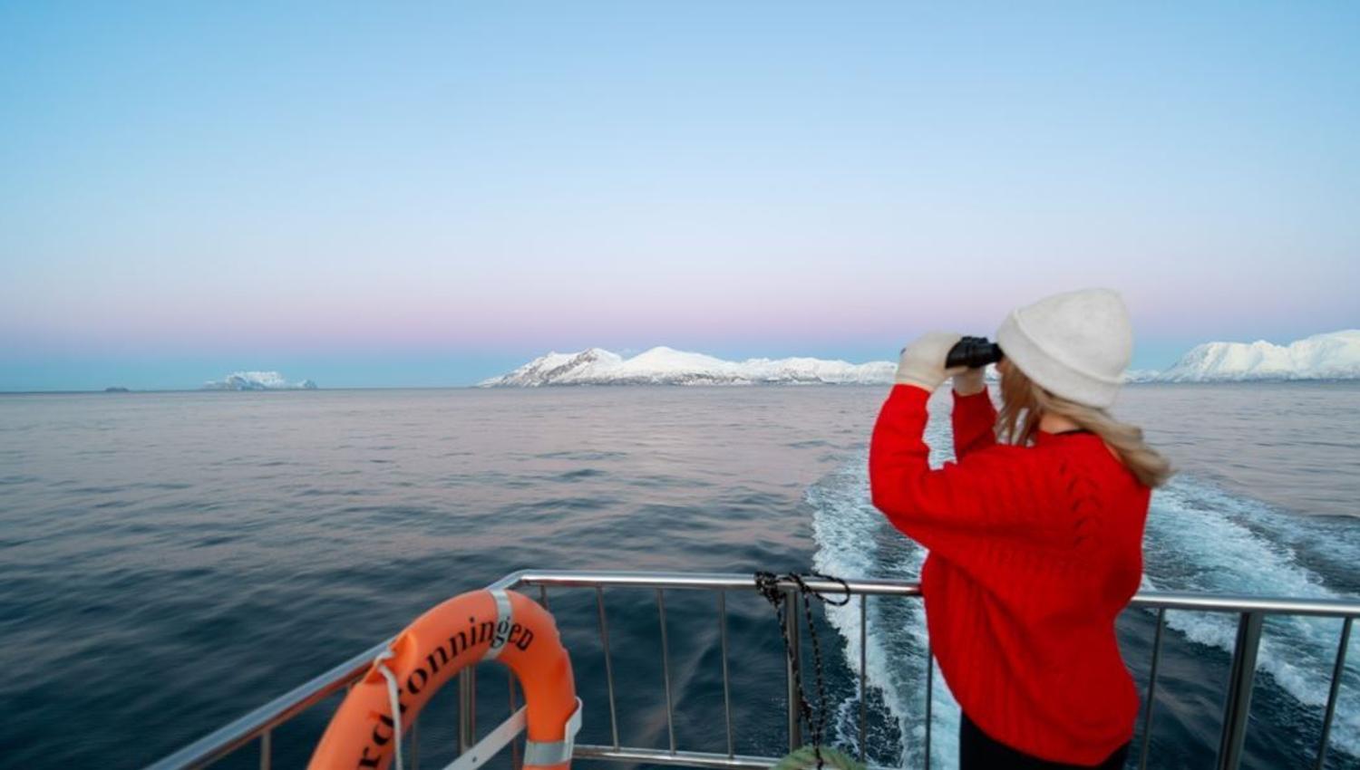 A women viewing the fjord from the boat's deck