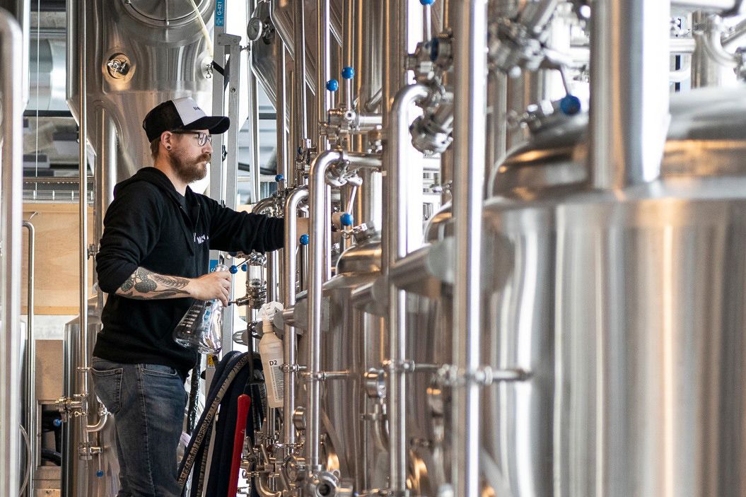 Bryggmesteren på Molo Brew tar prøver av brygget.