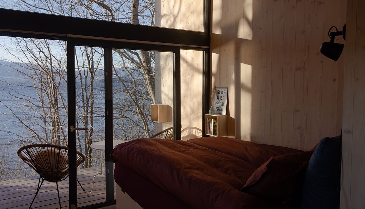 Sleeping area in the cabin with panoramic views over Hardangerfjord.