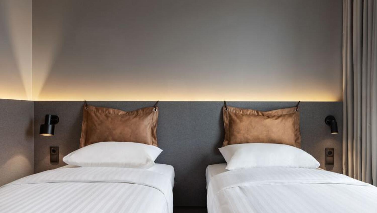 Bedroom with two beds at Moxy hotel.