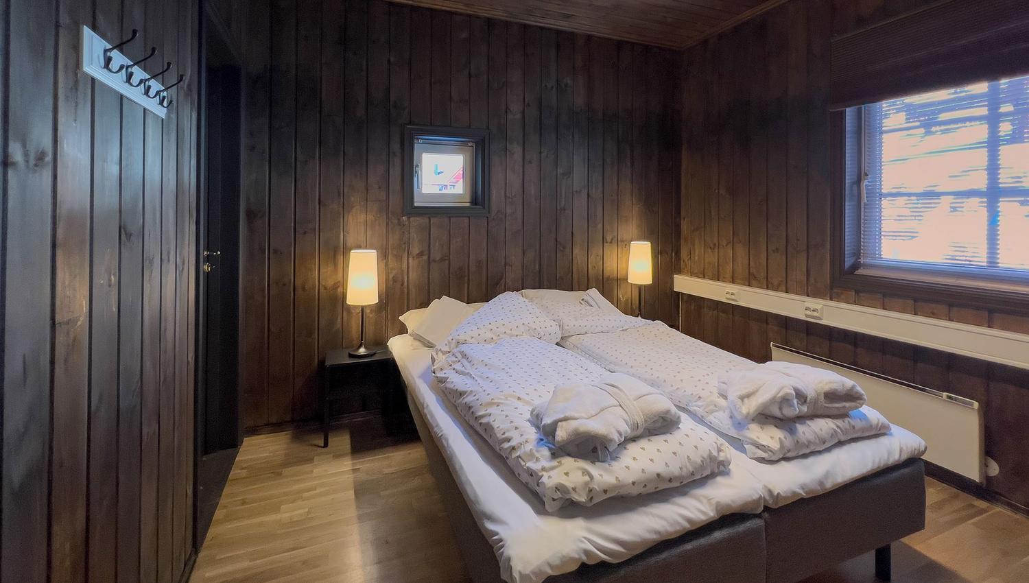 A room with a bed and a window.