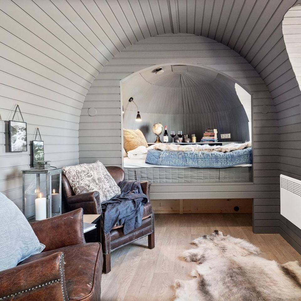 Bright modern interior of a wooden cabin pod with a bed and décor.