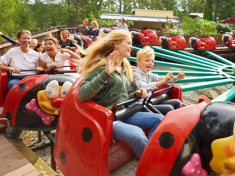 kids and grown ups in a roller coaster