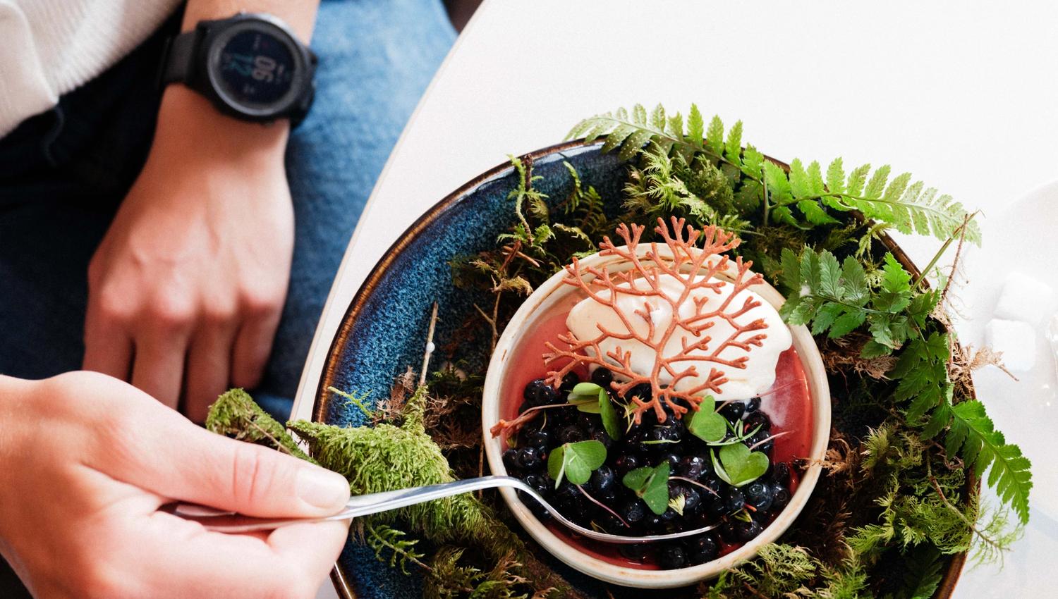 Kreativ dessert med blåbær, krem og skogsinspirert dekor – servert på Gløyp Spiseri.