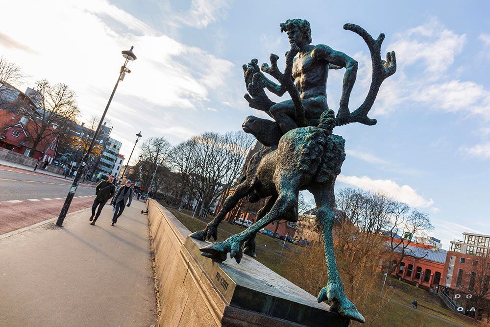 A statue of a man riding a moose on the bridge.