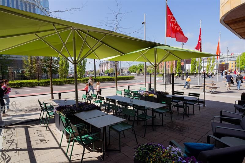 Outdoor seating towards the street, with Deichman and the harbour in the background