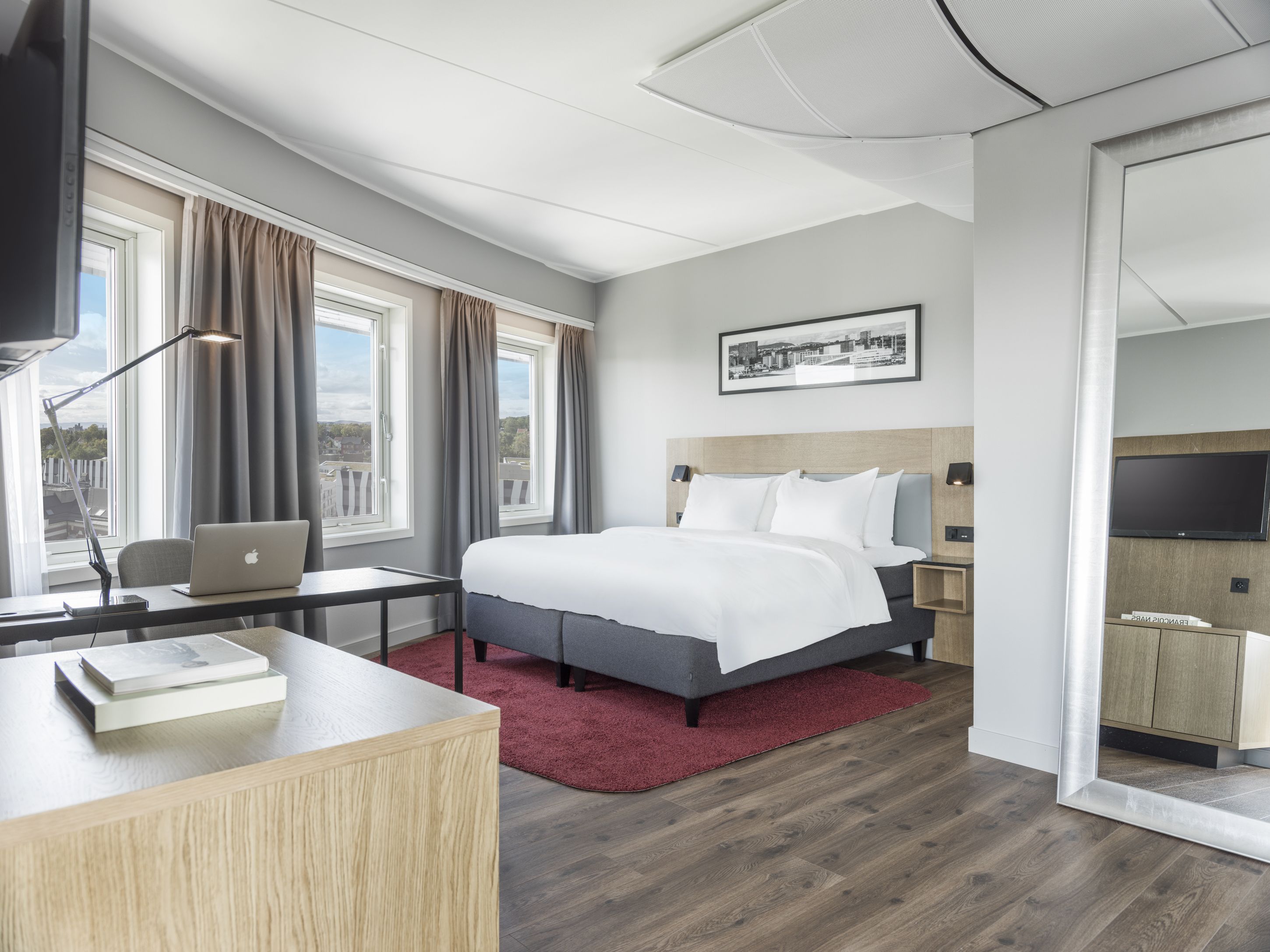 Junior suite. Bed, desk, full-length mirror. Photo 