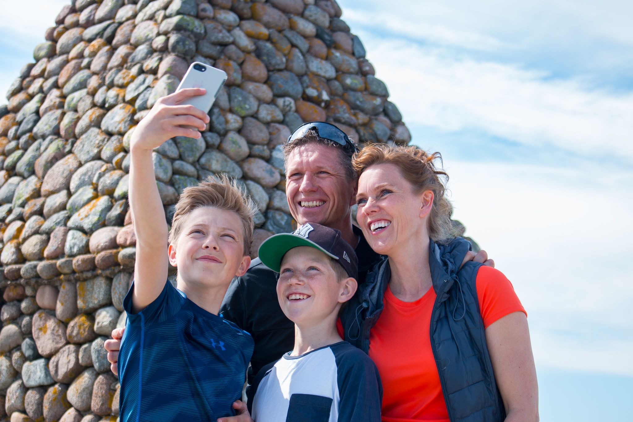 Family takes a selfie at the tilting lighthouse at the End of the World