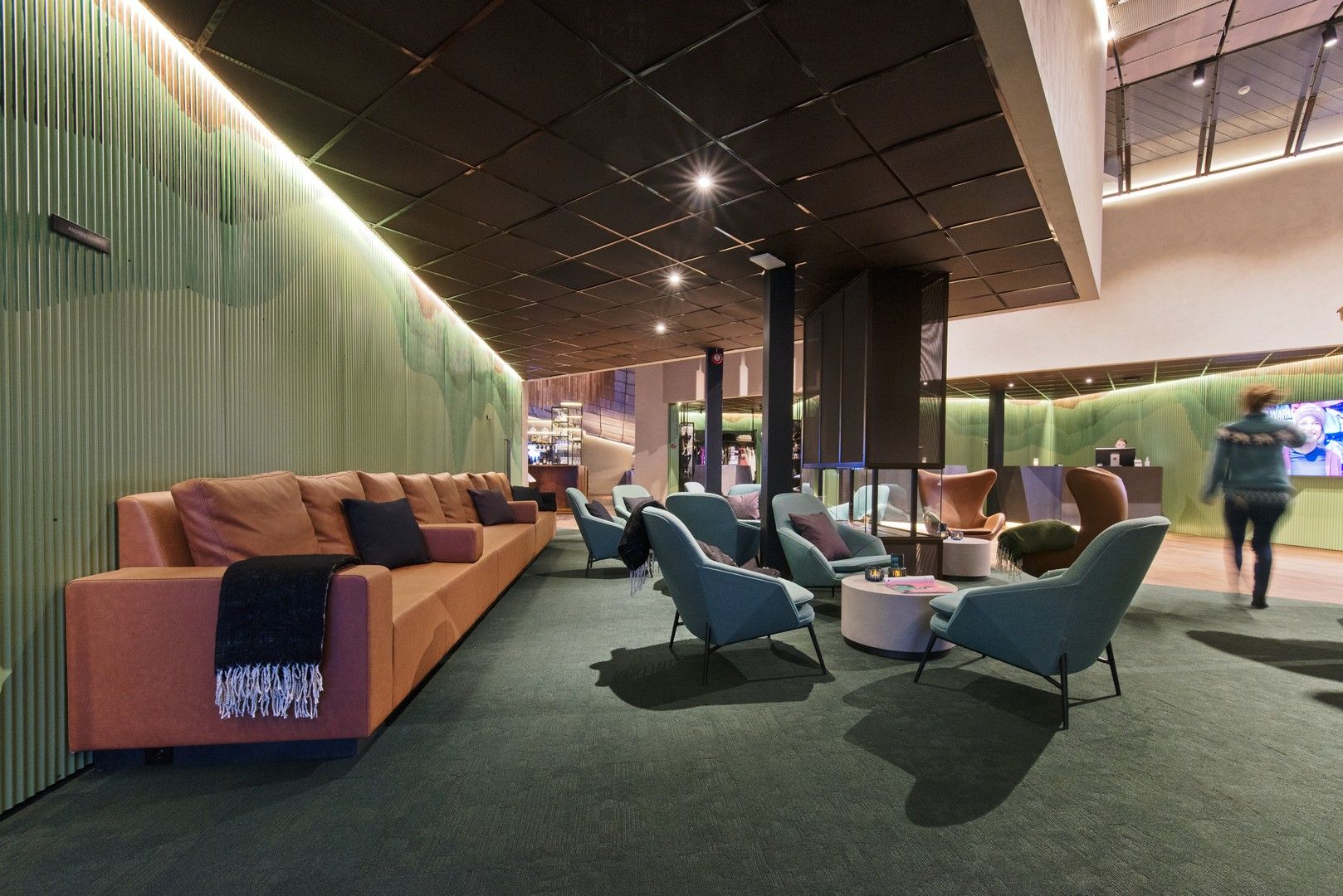 A hotel lobby with sofas and chairs