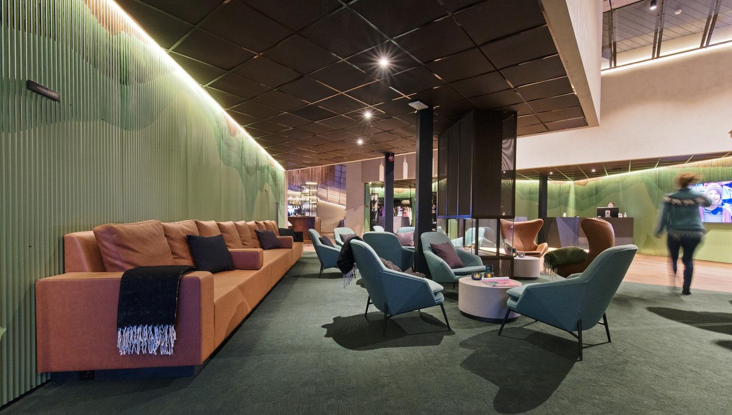 A hotel lobby with sofas and chairs