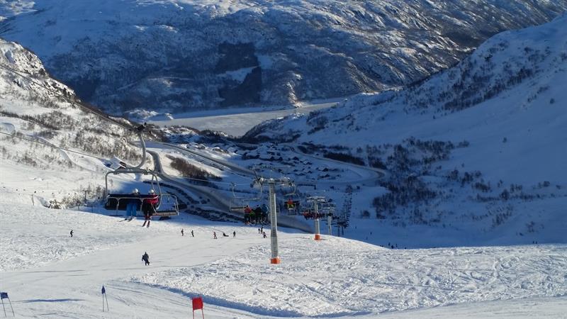 Chairlift operating at Røldal Ski Resort with panoramic views of the Hardanger mountains.