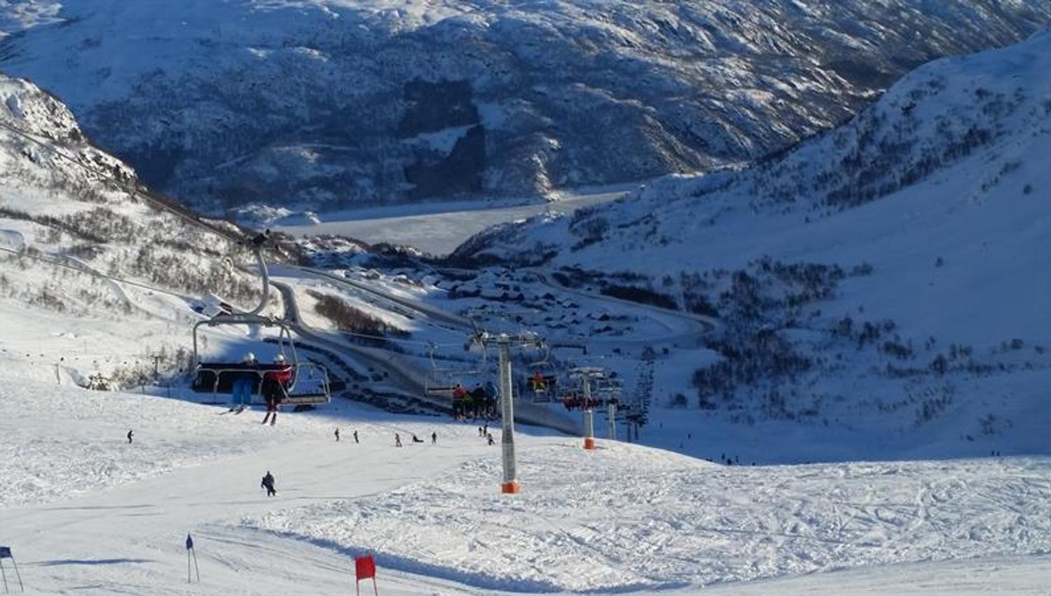 Chairlift operating at Røldal Ski Resort with panoramic views of the Hardanger mountains.