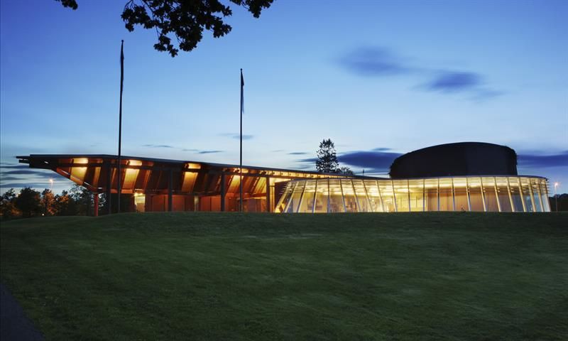 Overview picture, building facade in the evening in green grass