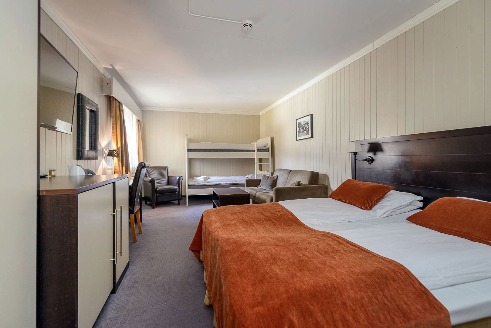 Junior suite with bed and bunk bed.