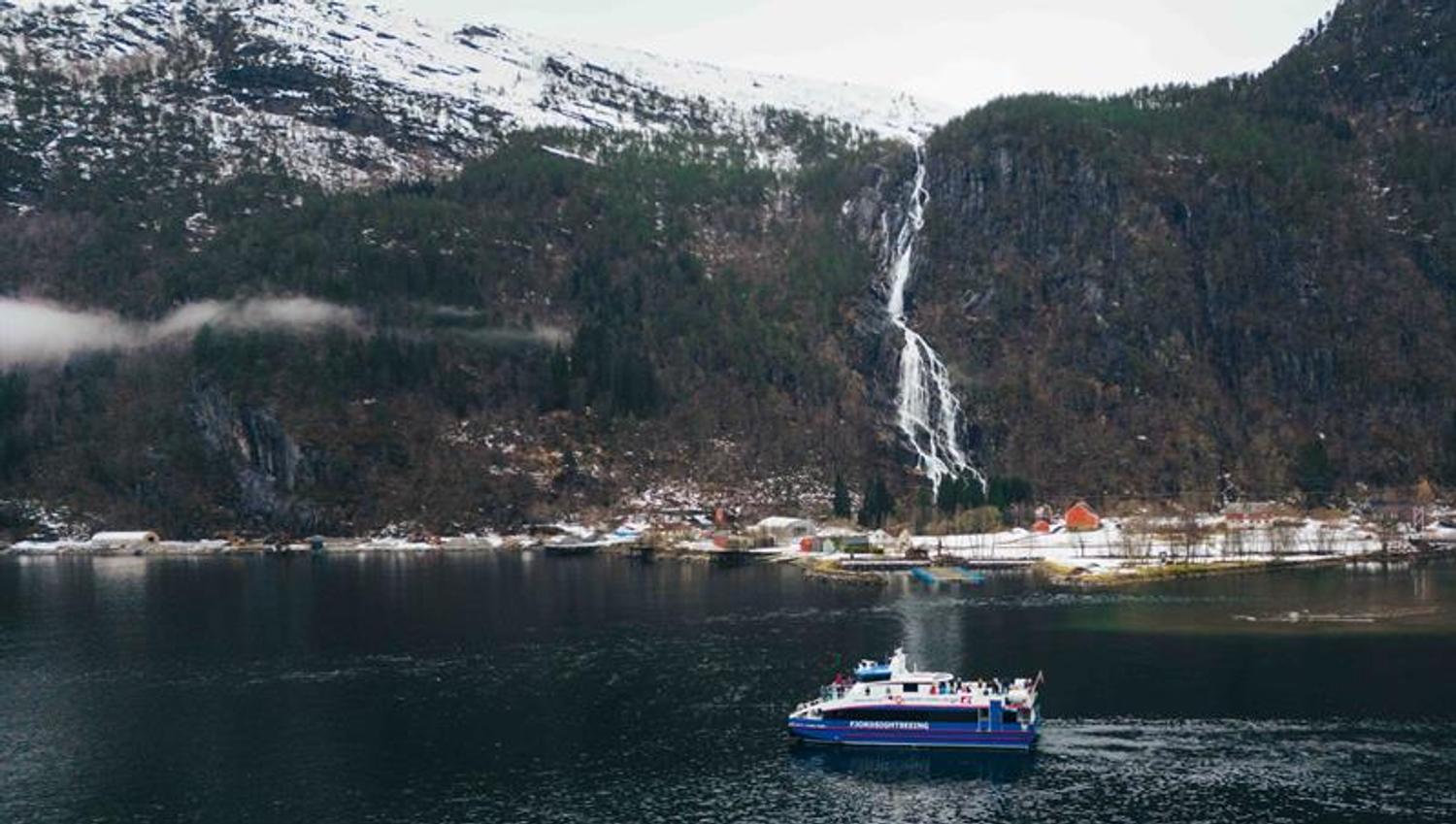 Steep mountains, fjord and waterfall