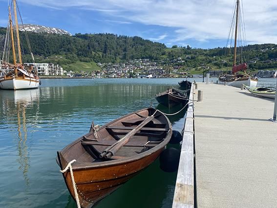 Rowboats docked at the pier at Hardanger Maritime Center.
