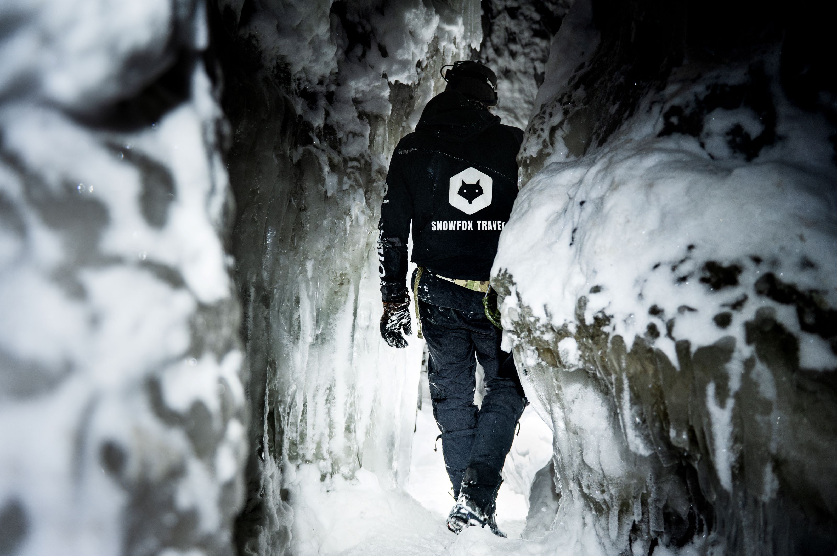 A person walking inside an ice cave