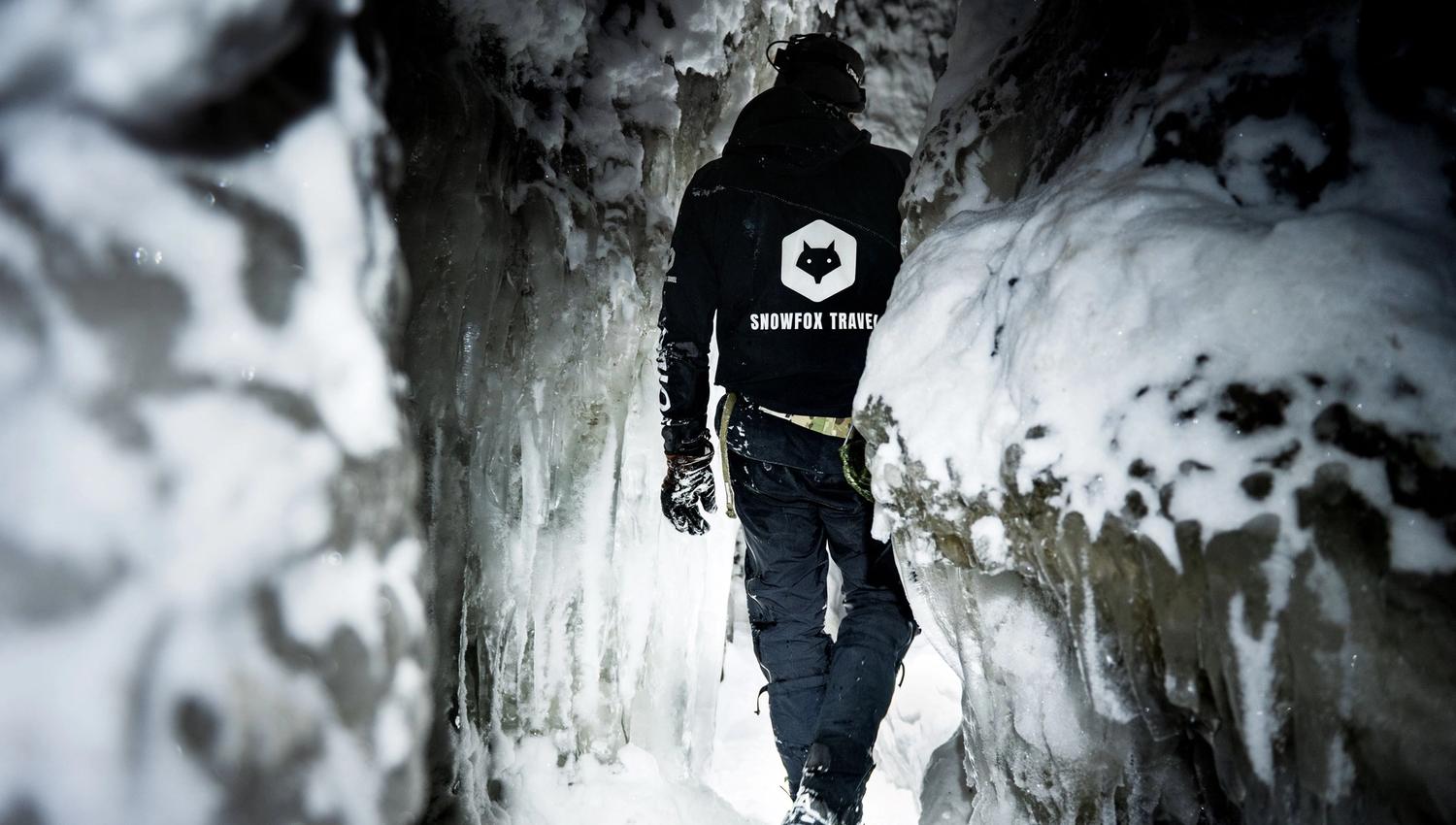 A person walking inside an ice cave