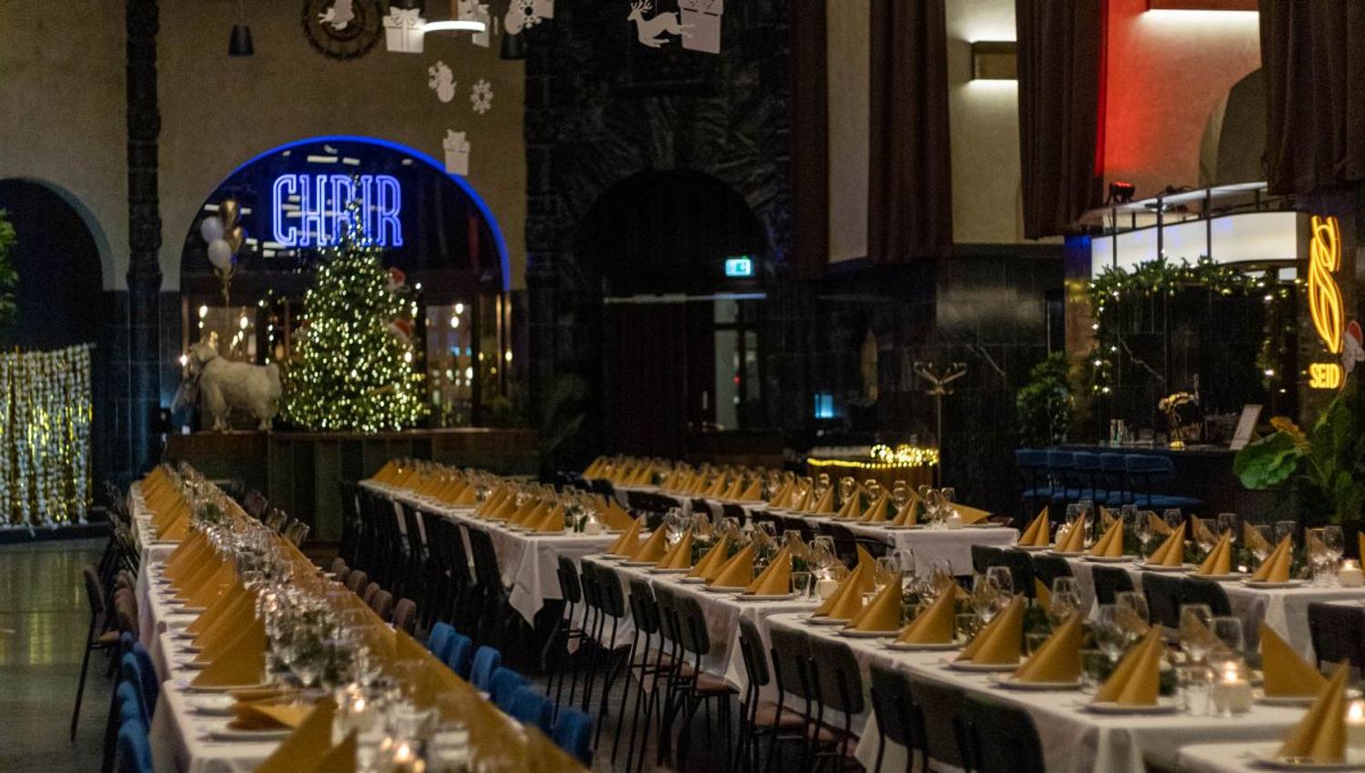 Long tables set for dinner for many people