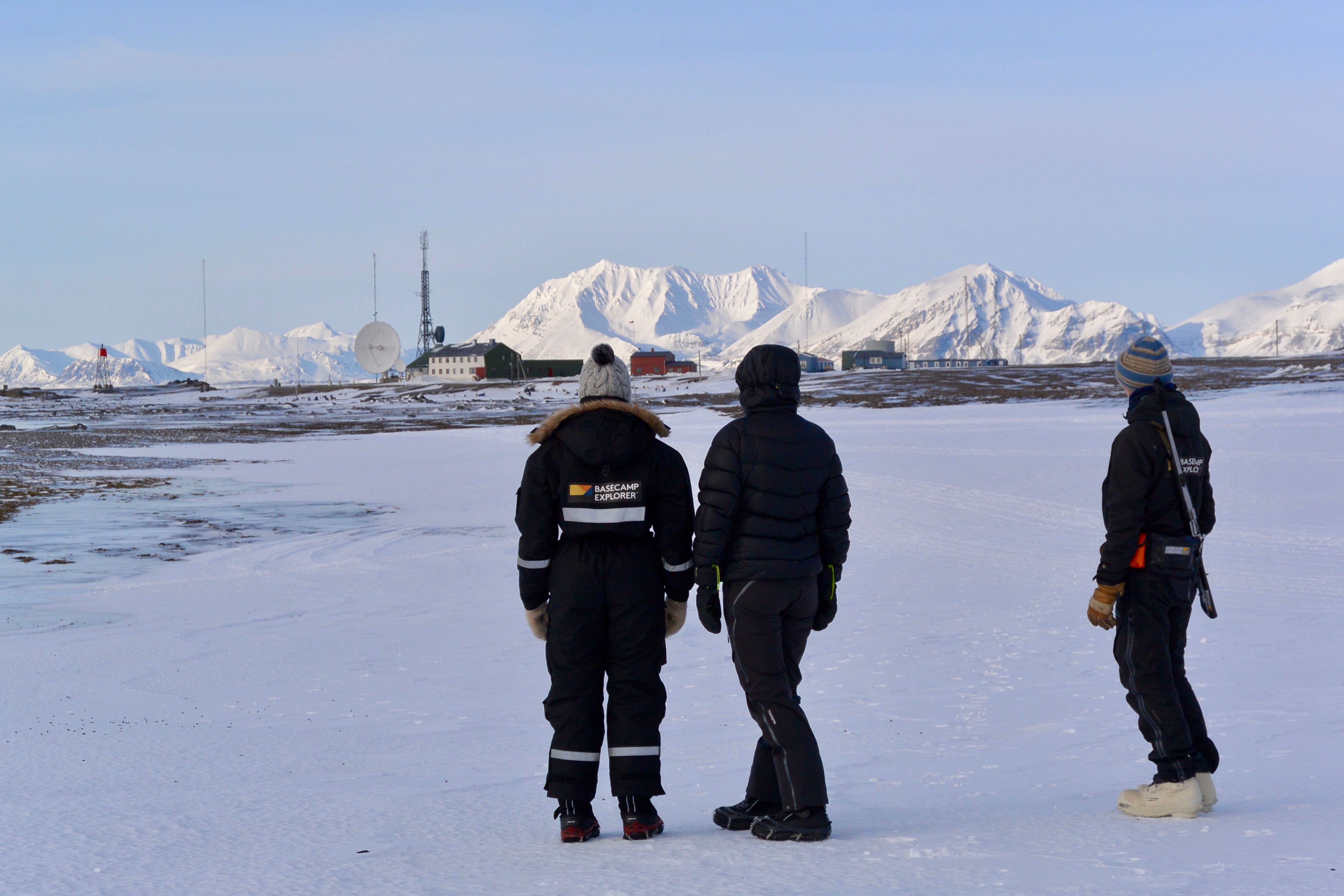 Guests and a guide looking towards Isfjord Radio