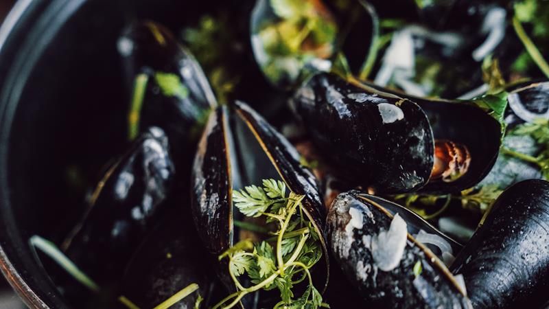 Pot of steamed mussels and parsley