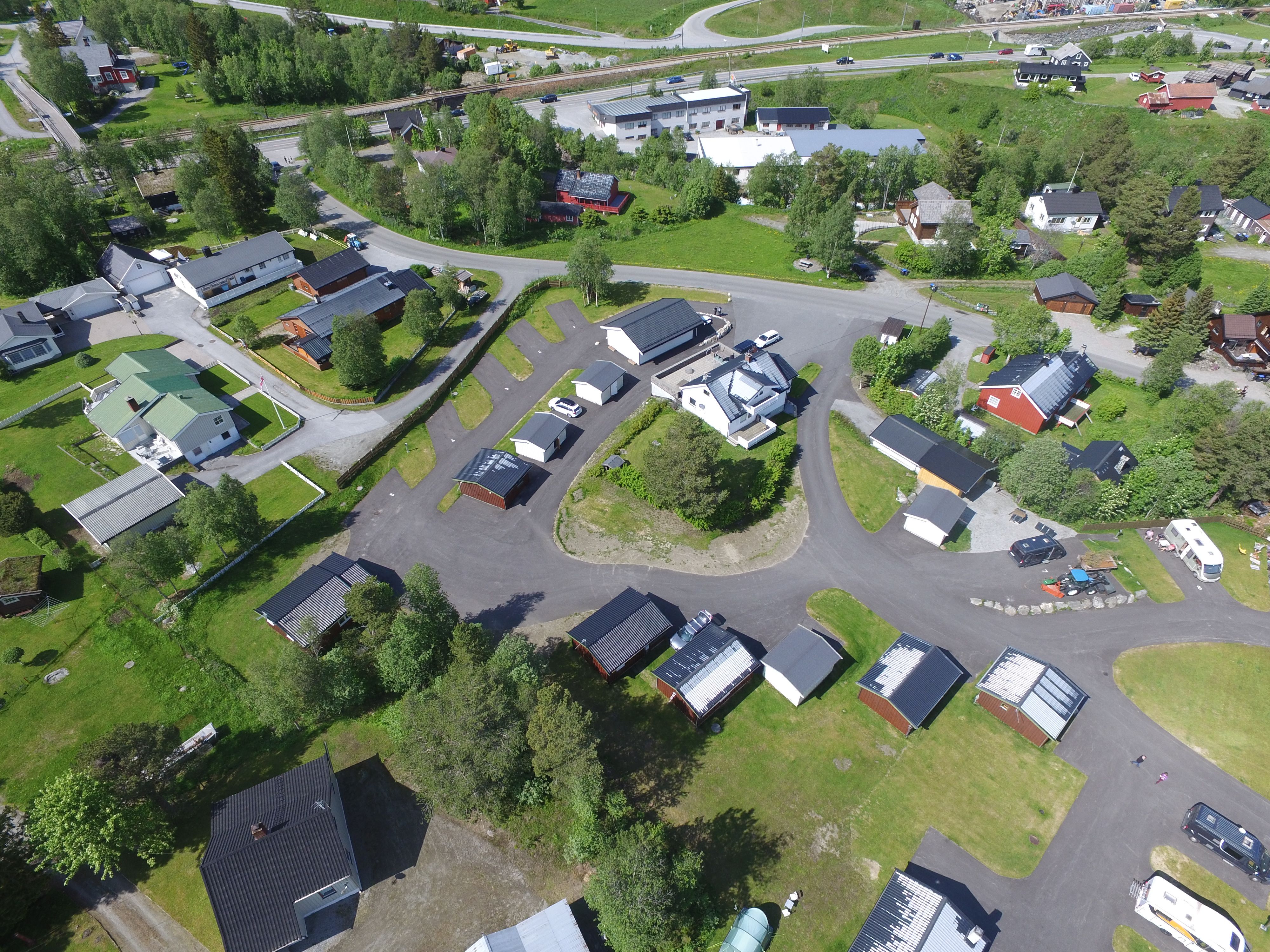 Drone view of camping in summer with camping pitches, cabins, reception and facility building 