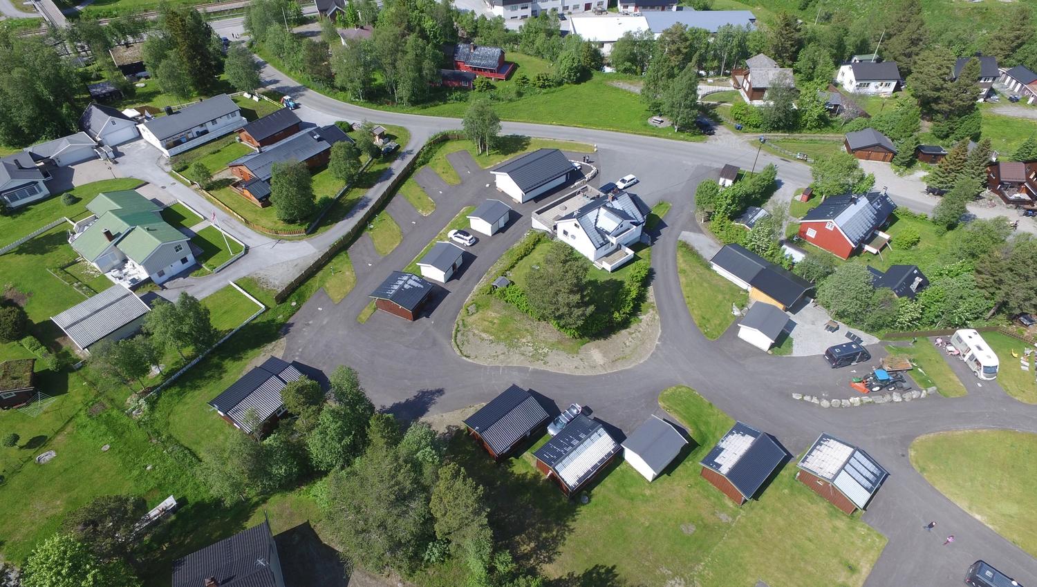 Drone view of camping in summer with camping pitches, cabins, reception and facility building
