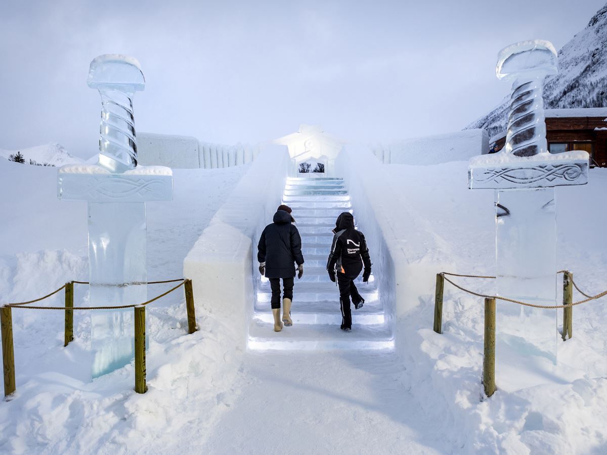 Guests walk up the snowy steps towards the Ice Domes