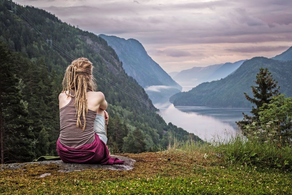 girl sitting on a rock in Rui Square and looking out over the Telemark Canal