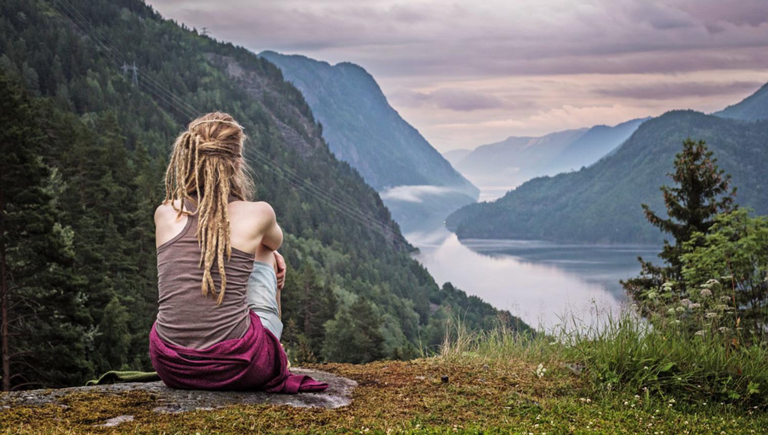 girl sitting on a rock in Rui Square and looking out over the Telemark Canal