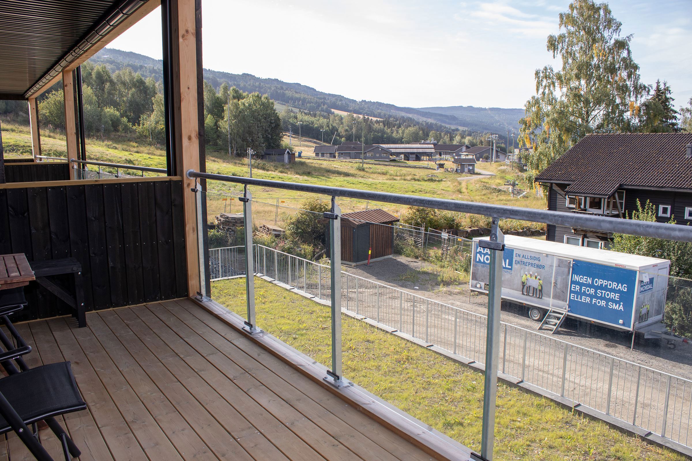 A balcony with railings and a view of Hafjell Bike Park