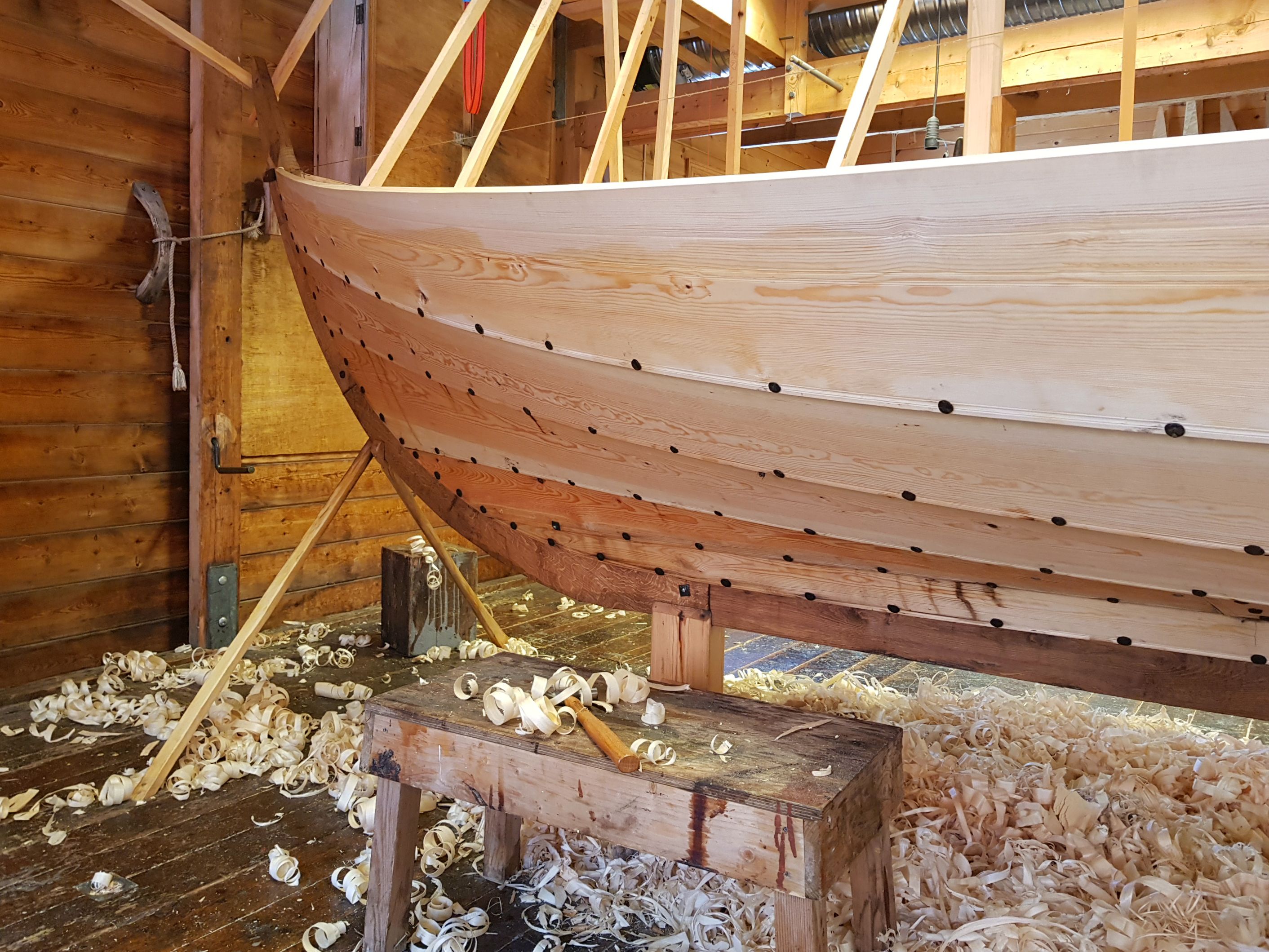 A traditional wooden boat under construction at the Hardanger Maritime Center workshop.