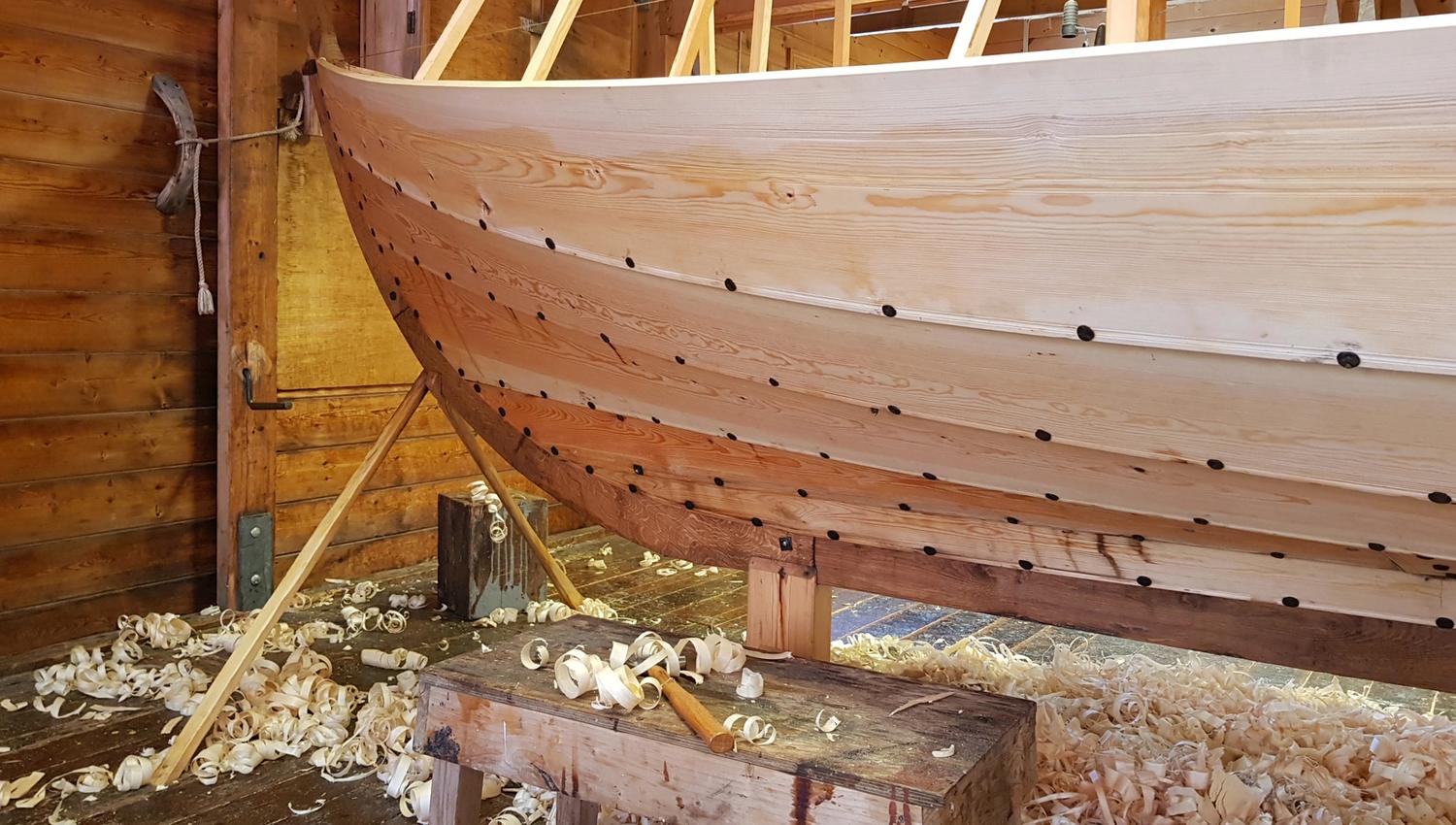 A traditional wooden boat under construction at the Hardanger Maritime Center workshop.
