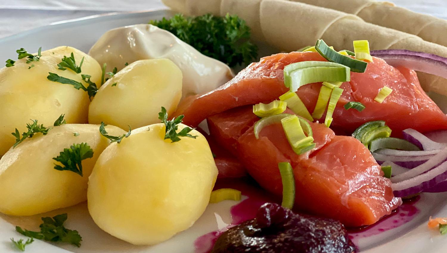 Rakfisk plate with boiled potatoes, semi-fermented trout and sides