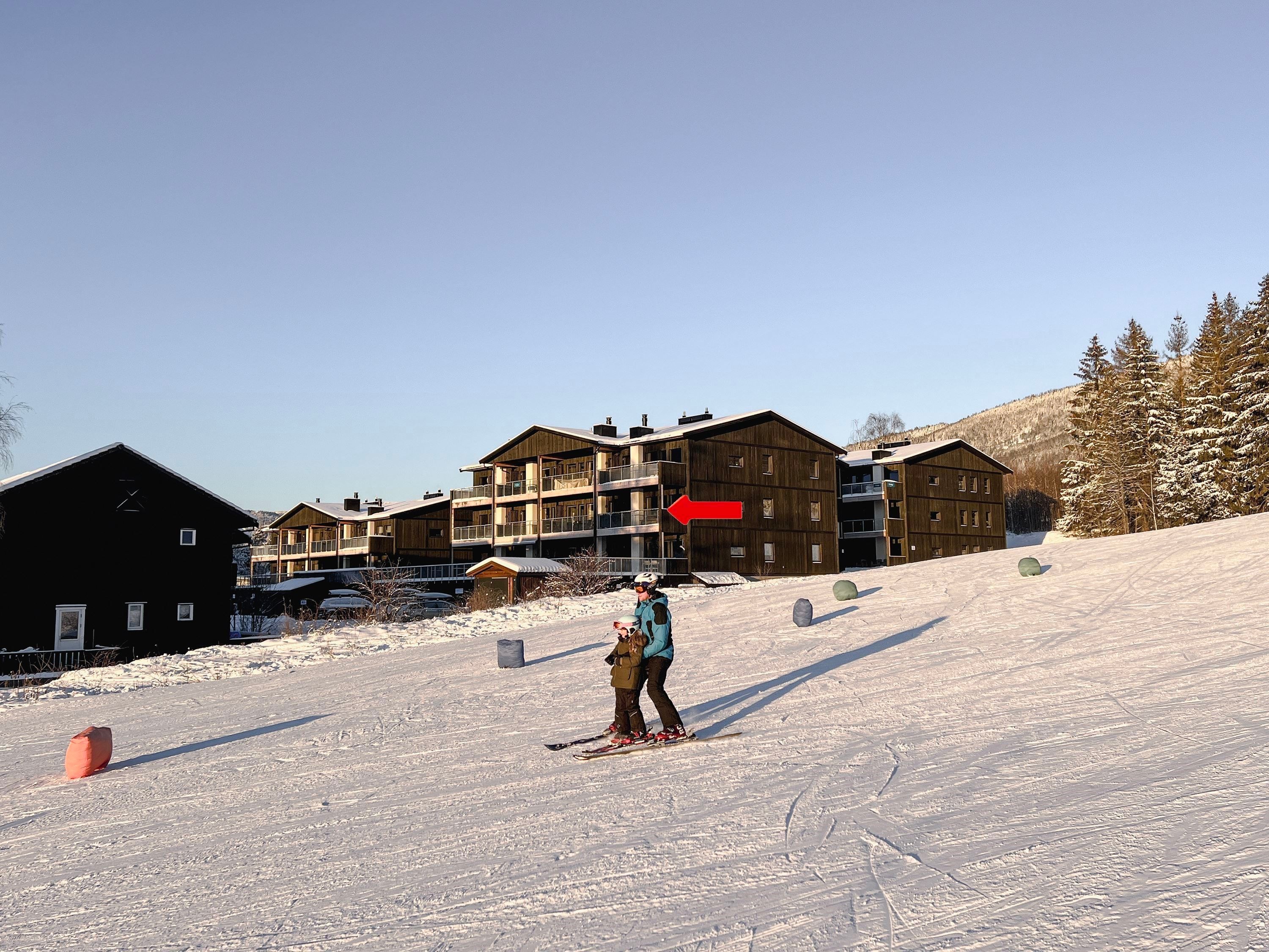 A couple of people skiing in the snow.