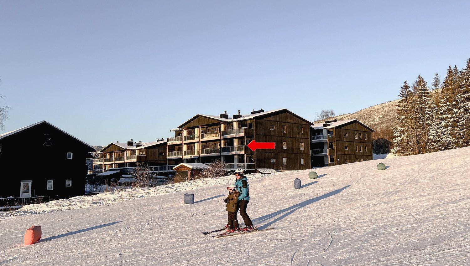 A couple of people skiing in the snow.