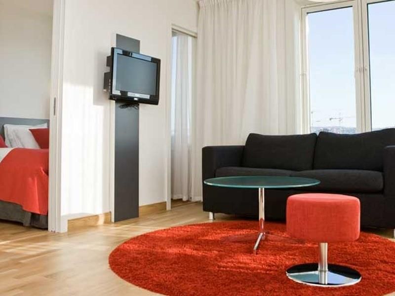 sofa corner with TV, and bed in a separate room