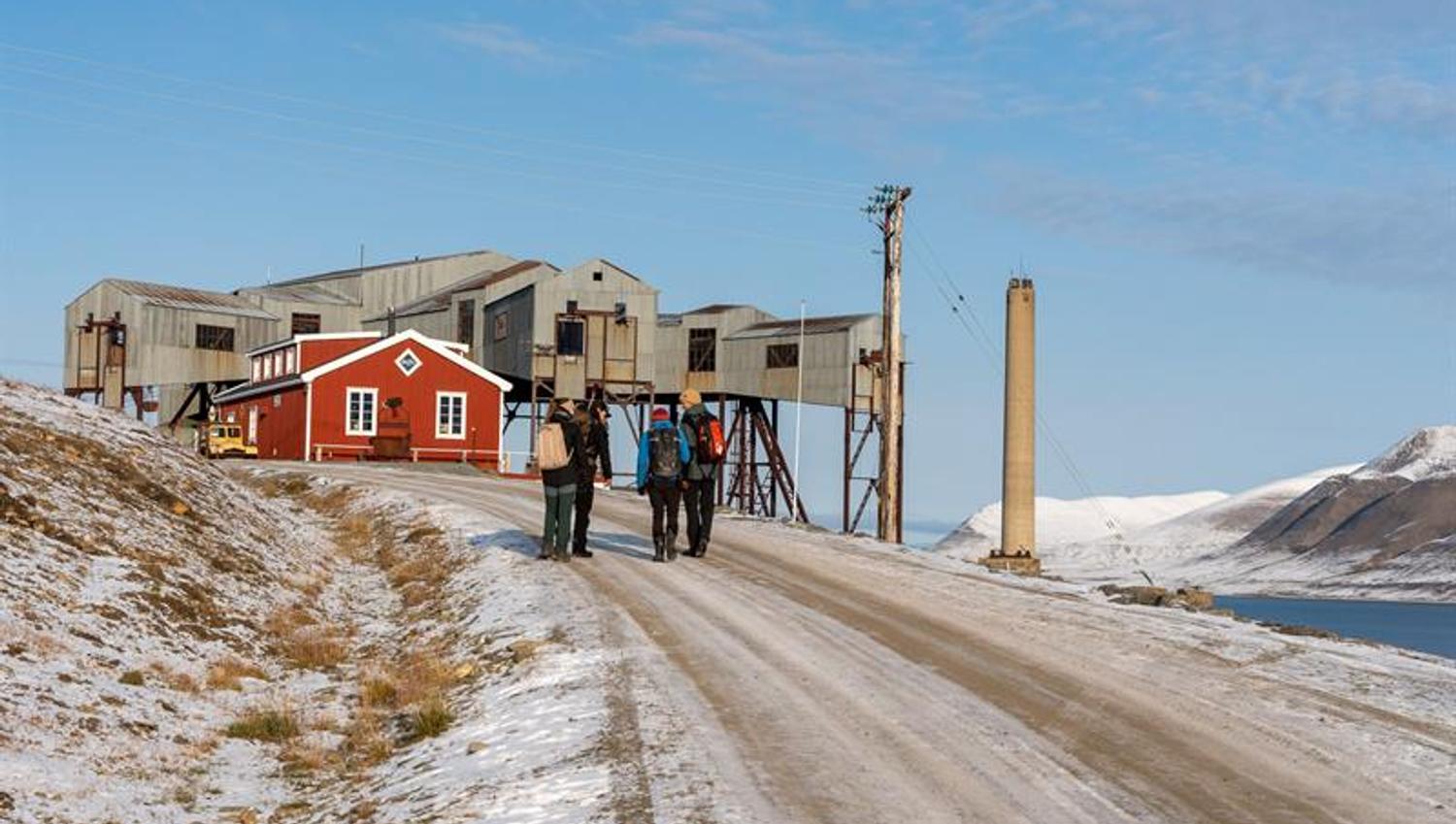 people on the road towards startingpoint. cableway central in the background