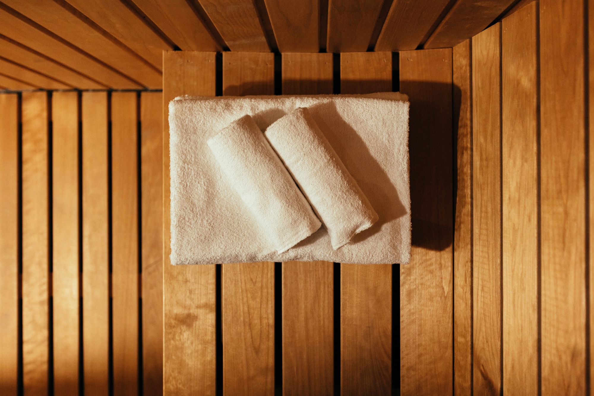 Sauna at Hardanger House with wooden interior and towels ready for relaxation.