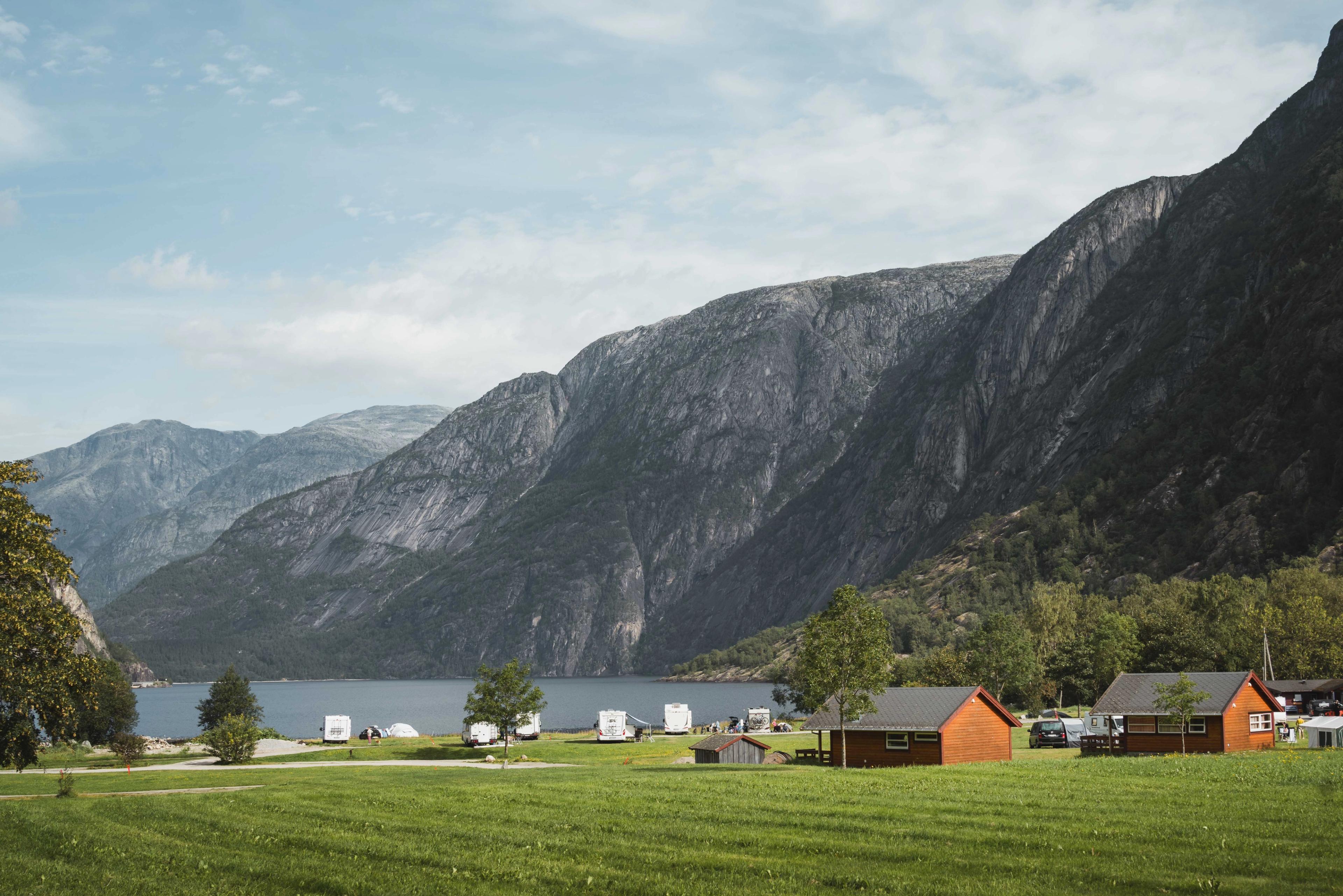Sæbø camping seen from the main road, with the lake and mountains in the background.