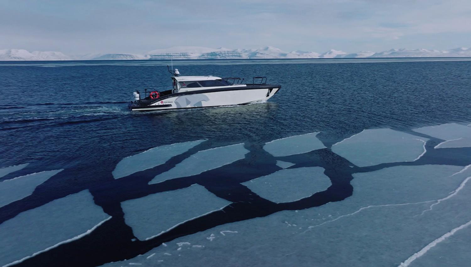 A boat sailing along sheets of ice floating on a fjord, with snow-covered mountains far away in the background