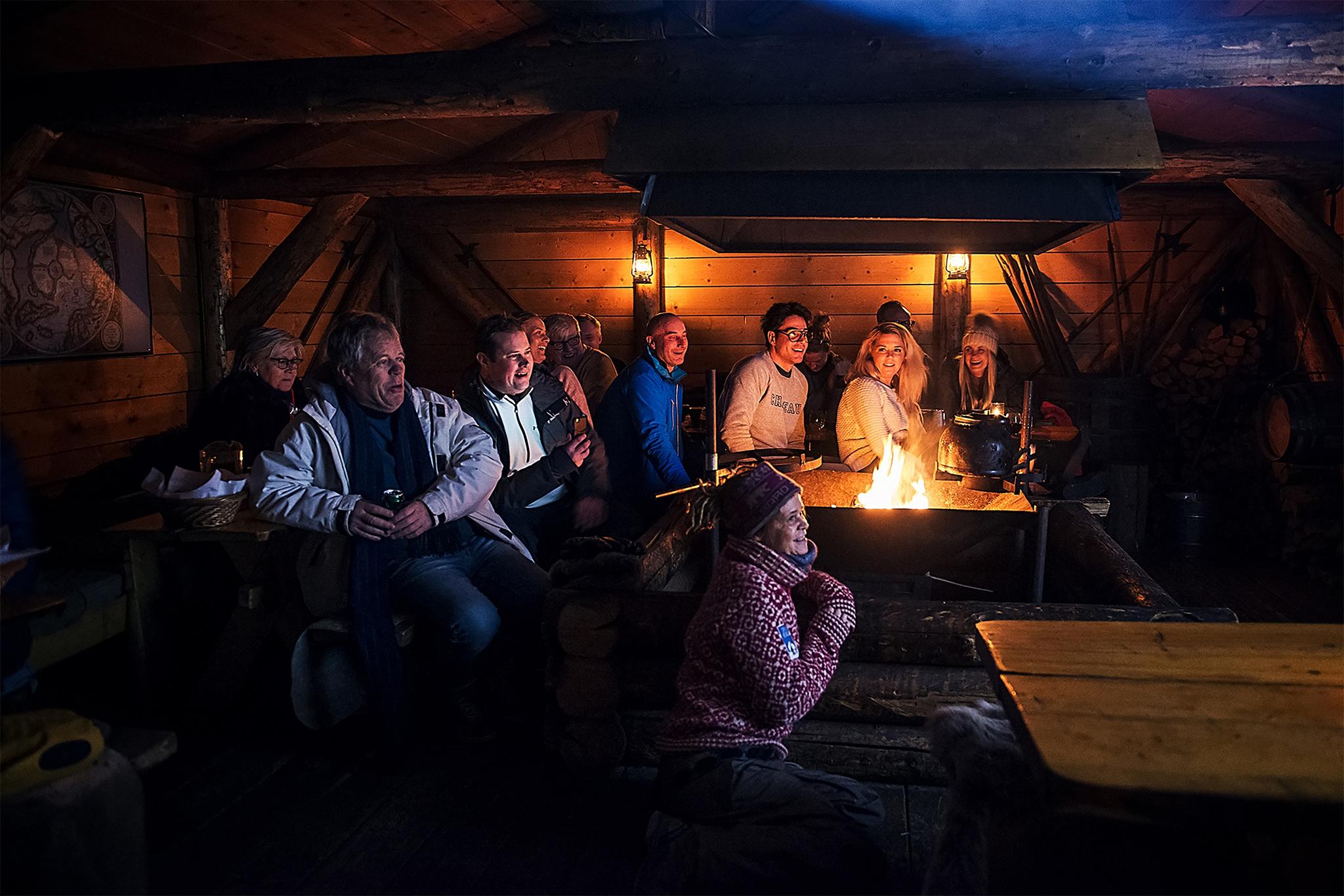 Guests listening to a lecture inside the cabin at Camp Barentz