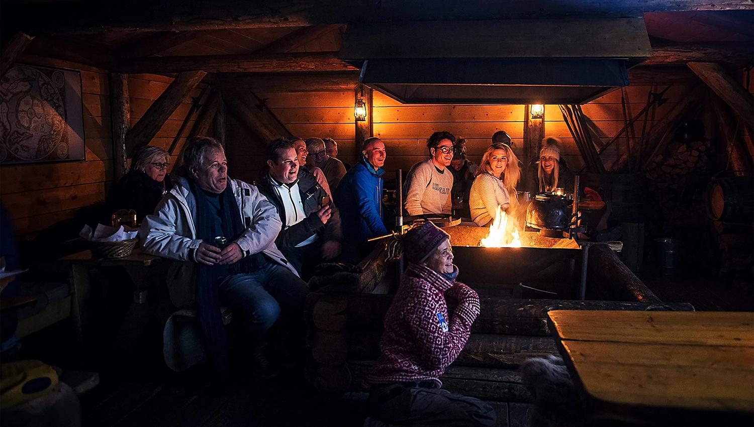 Guests listening to a lecture inside the cabin at Camp Barentz