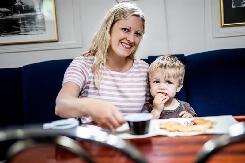mother and son enjoying waffles in the restaurant on MS Fram 