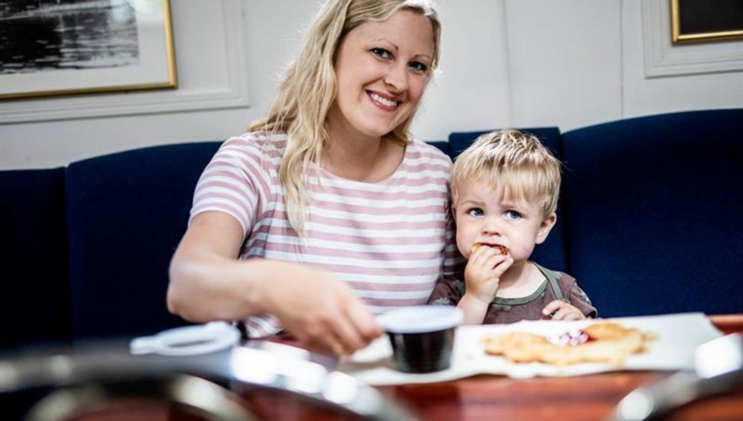 mother and son enjoying waffles in the restaurant on MS Fram