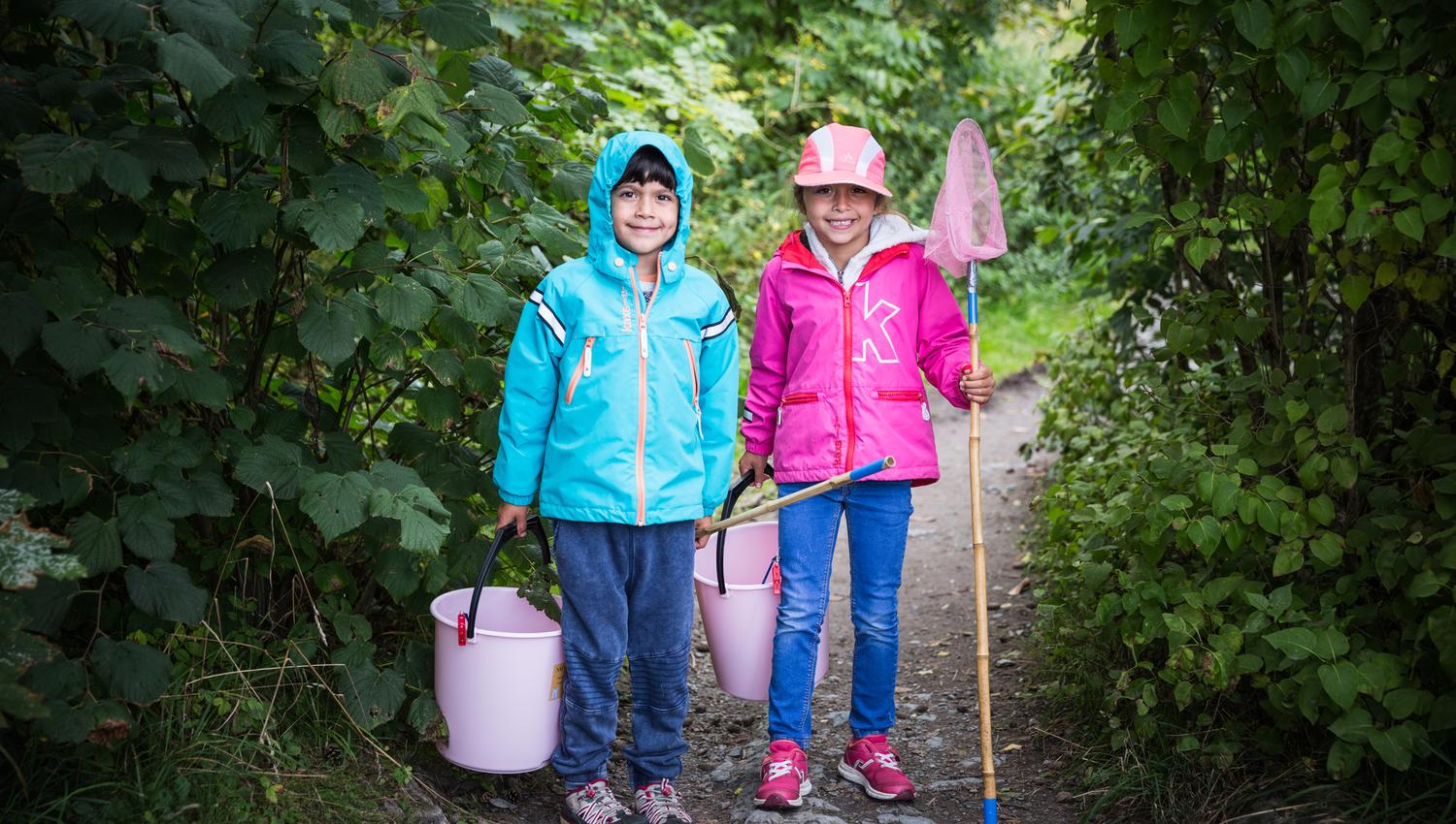 Two kids fishing, green forest